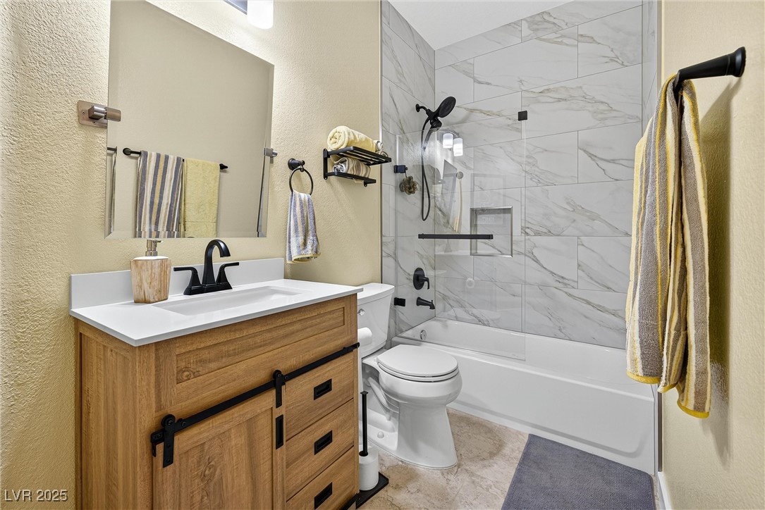 980 Upper Meadows Place Henderson, NV 89052 - Photo 28 of 58 Bathroom with a textured wall, tub / shower combination, and vanity