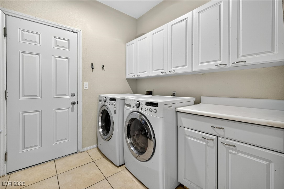 980 Upper Meadows Place Henderson, NV 89052 - Photo 29 of 58 Washroom with light tile patterned floors, cabinet space, and separate washer and dryer