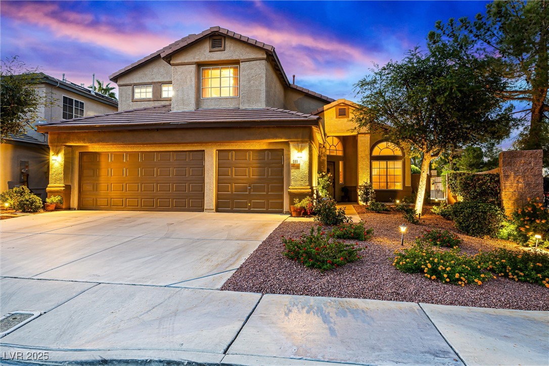 980 Upper Meadows Place Henderson, NV 89052 - Photo 3 of 58 View of front facade with concrete driveway, stucco siding, a tile roof, and an attached garage