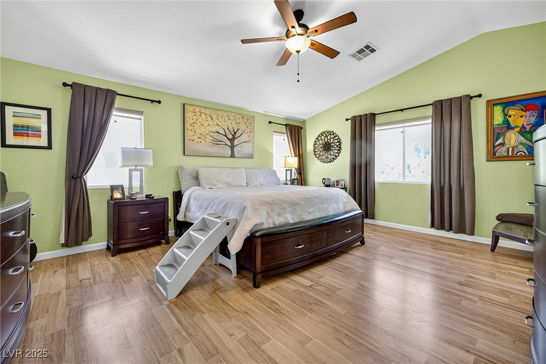 980 Upper Meadows Place Henderson, NV 89052 - Photo 30 of 58 Bedroom featuring multiple windows, light wood-type flooring, vaulted ceiling, and ceiling fan