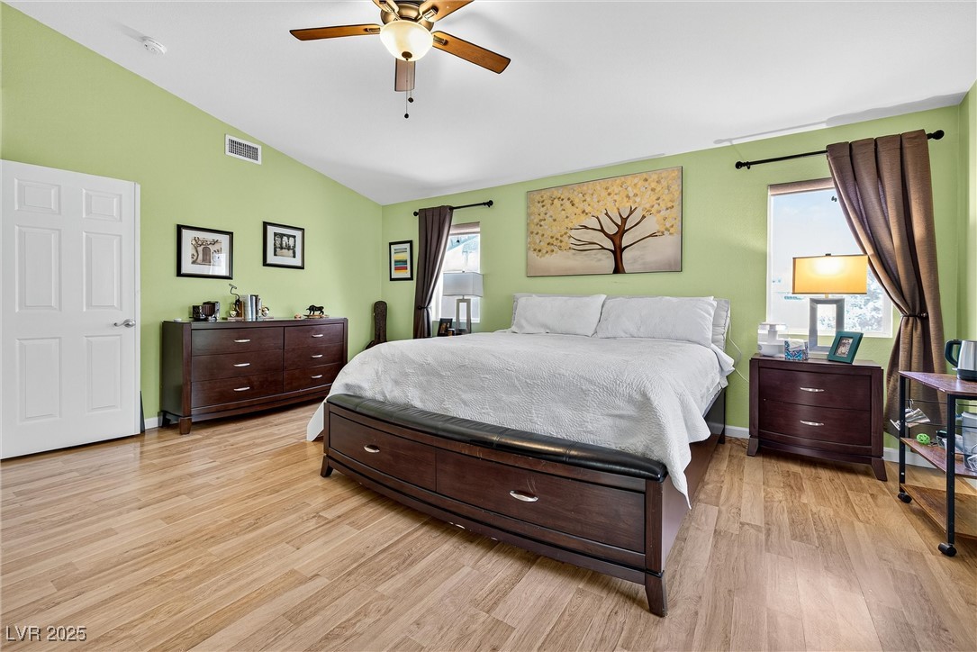 980 Upper Meadows Place Henderson, NV 89052 - Photo 31 of 58 Bedroom with lofted ceiling, light wood-style flooring, and a ceiling fan