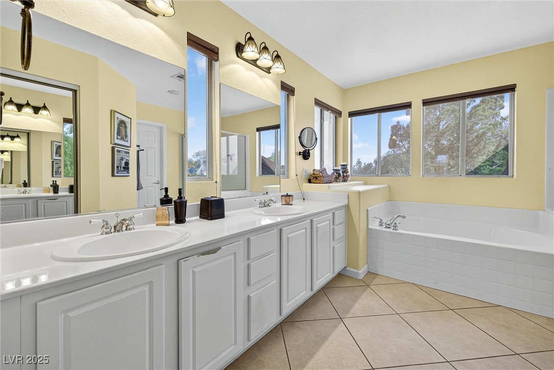980 Upper Meadows Place Henderson, NV 89052 - Photo 33 of 58 Full bath featuring a bath, double vanity, and light tile patterned floors