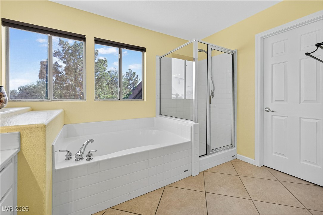 980 Upper Meadows Place Henderson, NV 89052 - Photo 34 of 58 Full bath featuring a shower stall, a garden tub, light tile patterned floors, and vanity