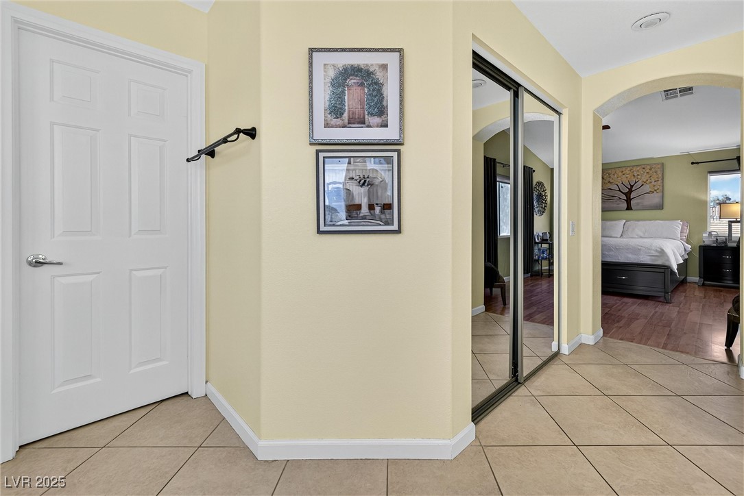 980 Upper Meadows Place Henderson, NV 89052 - Photo 35 of 58 Hall with light tile patterned floors and arched walkways