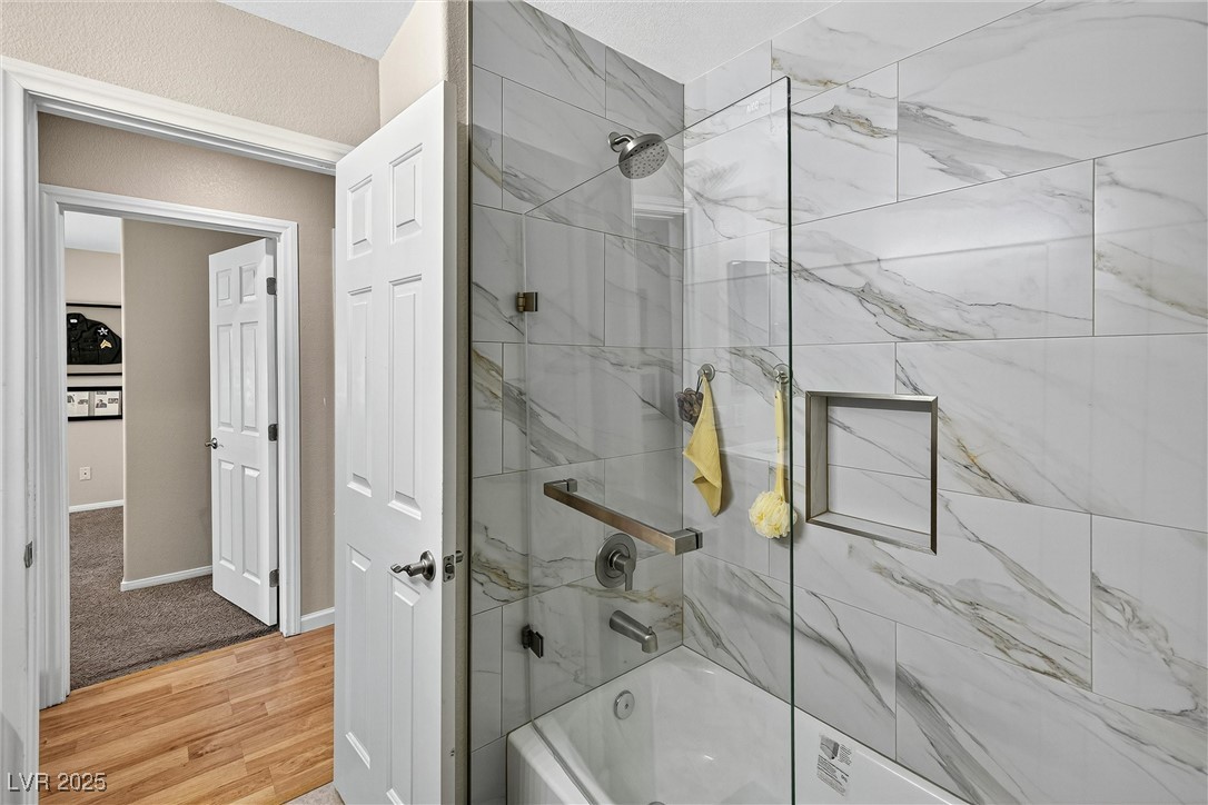 980 Upper Meadows Place Henderson, NV 89052 - Photo 39 of 58 Full bathroom featuring bath / shower combo with glass door and light wood-style flooring