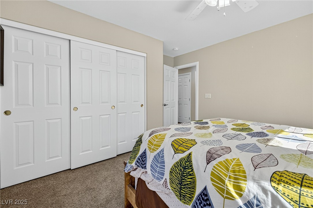 980 Upper Meadows Place Henderson, NV 89052 - Photo 41 of 58 Bedroom with carpet, a closet, and ceiling fan