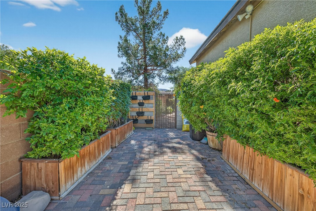 980 Upper Meadows Place Henderson, NV 89052 - Photo 50 of 58 View of community featuring a patio and a gate