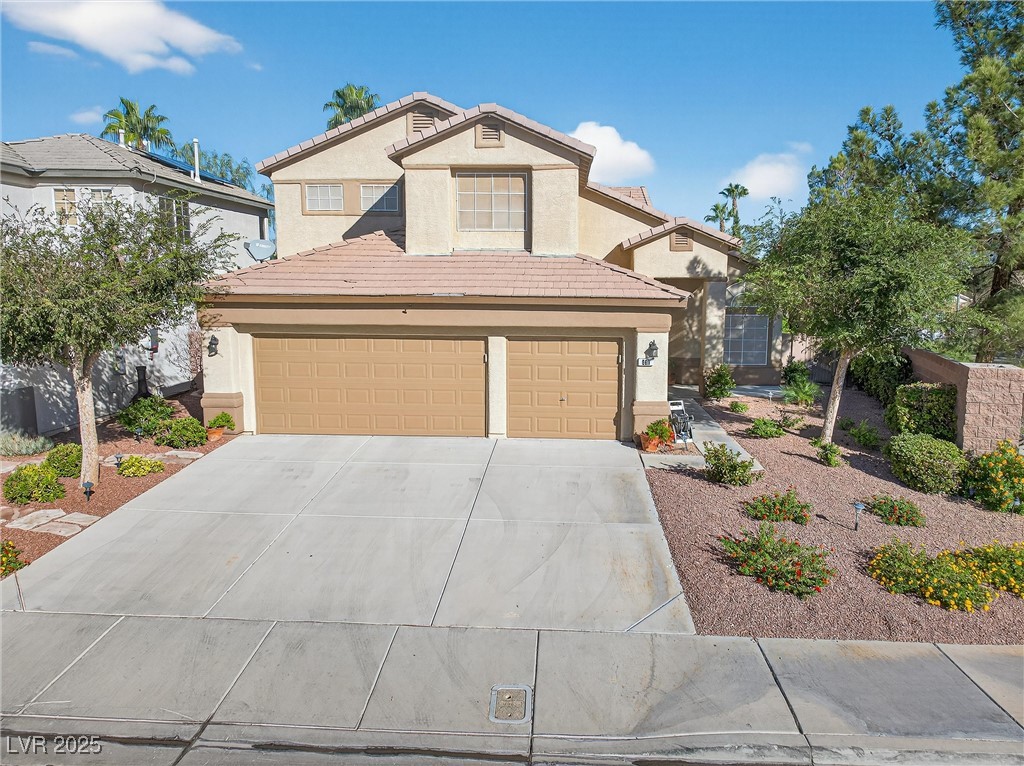 980 Upper Meadows Place Henderson, NV 89052 - Photo 51 of 58 Traditional-style house with stucco siding, a tiled roof, concrete driveway, and a garage