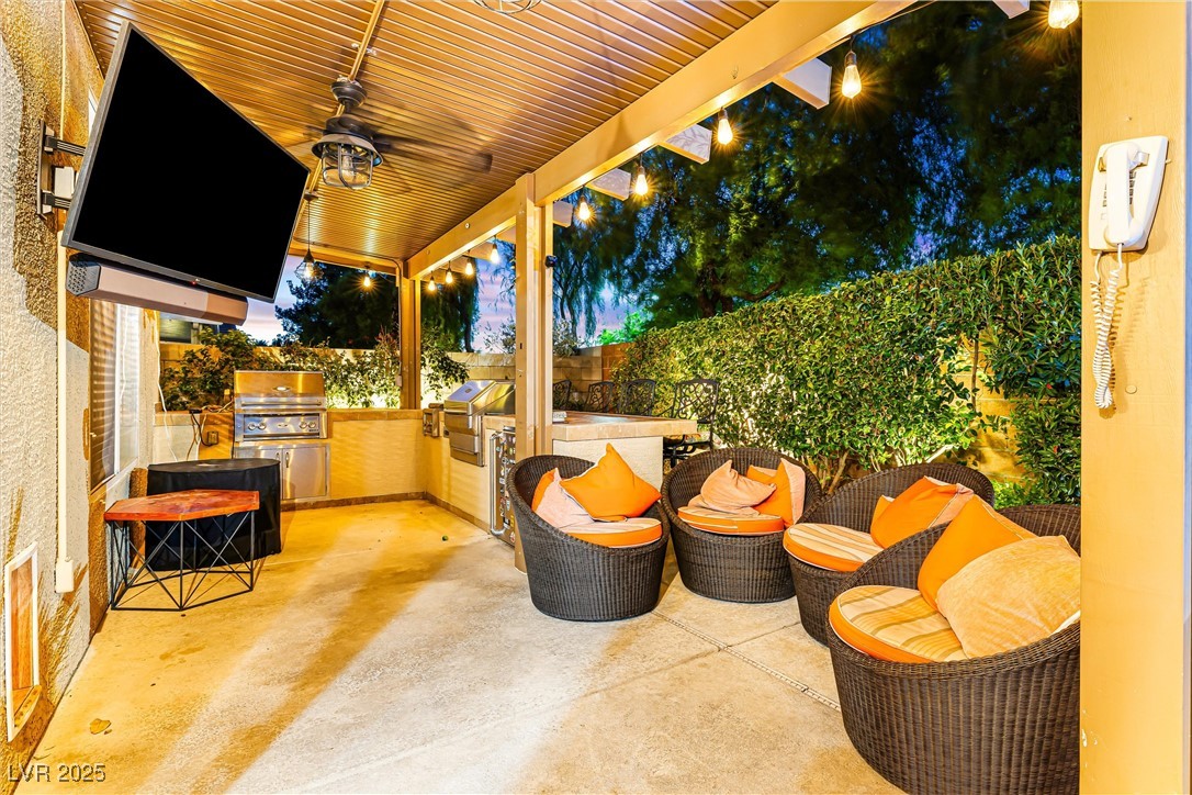 980 Upper Meadows Place Henderson, NV 89052 - Photo 7 of 58 Fenced backyard with area for grilling, a ceiling fan, and a patio