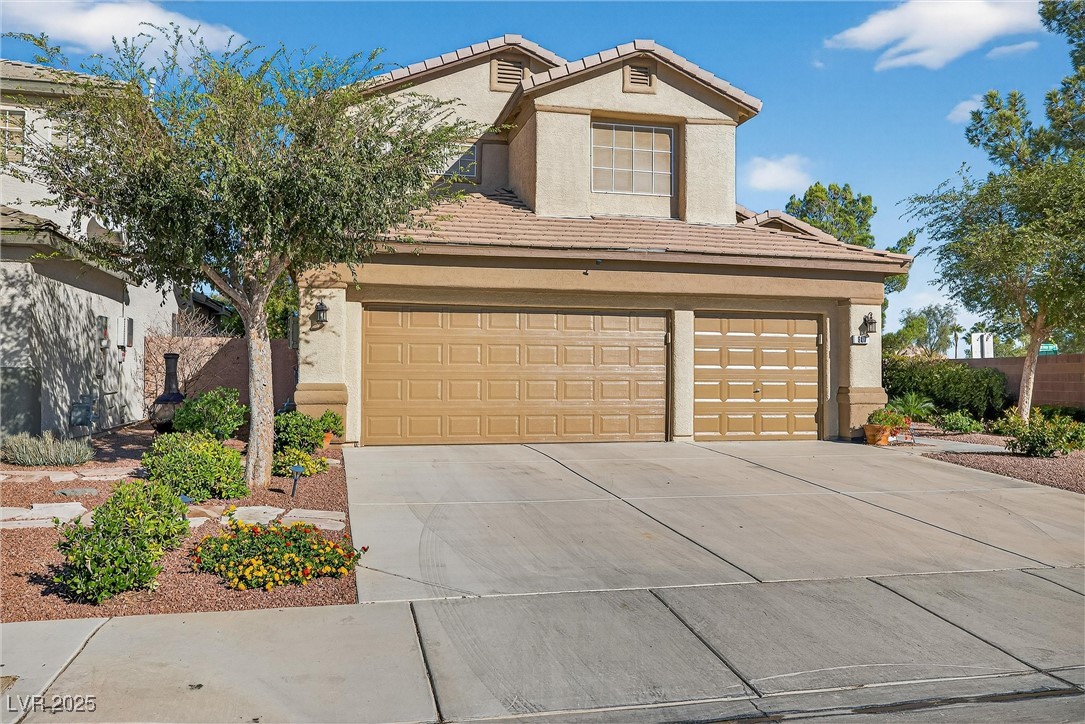 980 Upper Meadows Place Henderson, NV 89052 - Photo 9 of 58 Traditional-style home with stucco siding, a tile roof, driveway, and a garage
