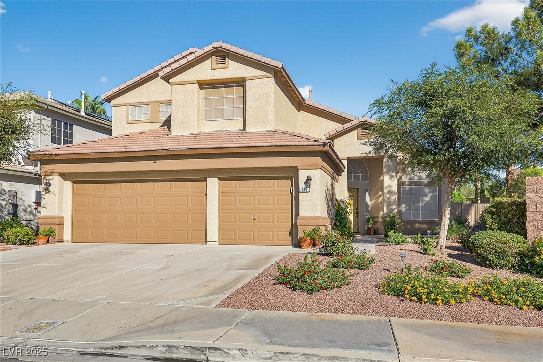 980 Upper Meadows Place Henderson, NV 89052 - Photo 10 of 58 View of front facade with stucco siding, concrete driveway, a garage, and a tile roof