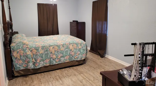 a bedroom with a bed and a dresser in it