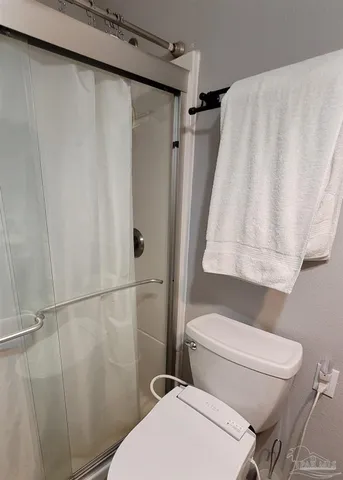 a bedroom with a bed and a mirror