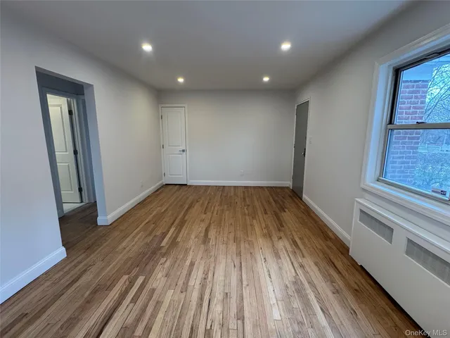 a view of a room with wooden floor and staircase
