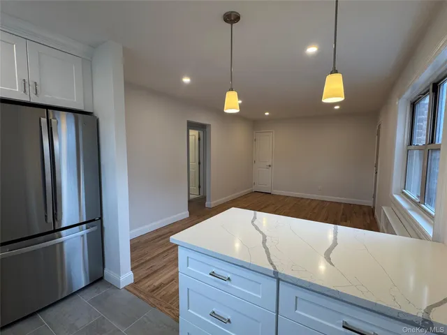 a kitchen with a refrigerator and cabinets