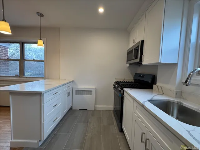 a kitchen that has a sink and a stove in it