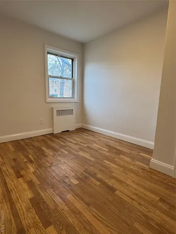 a view of a room with wooden floor and windows in it