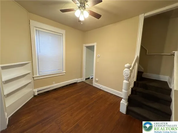 a view of an empty room with wooden floor