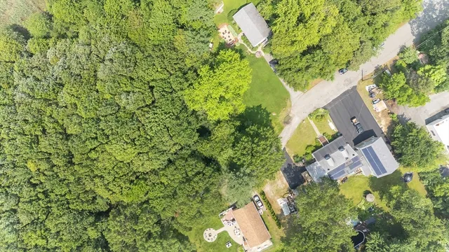 an aerial view of a house with a yard
