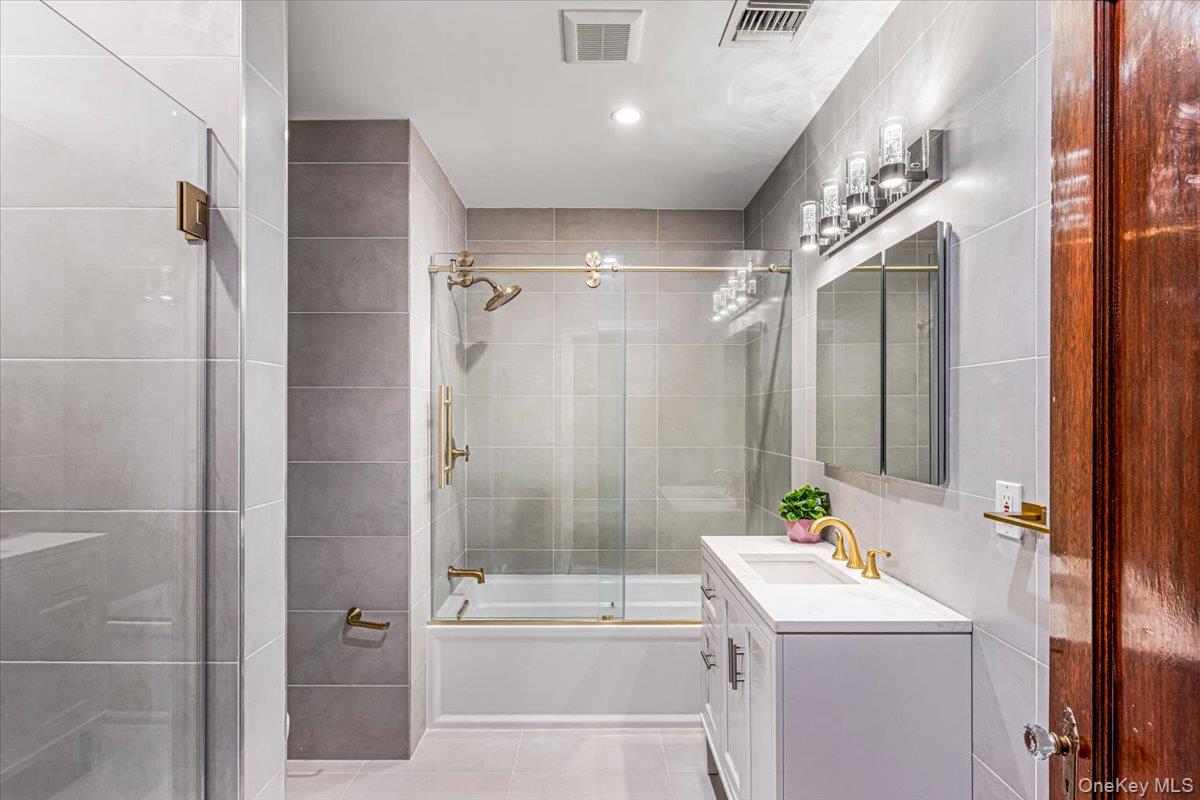 952 Cedar Swamp Road Glen Head, NY 11545 - Photo 28 of 50 a bathroom with a sink a toilet and shower