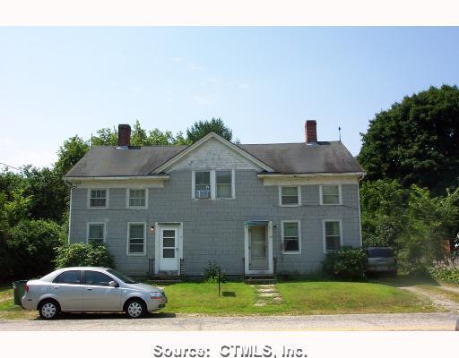 75 River Street Sprague, CT 06330 - Photo 1 of 1 a front view of a house with a garden