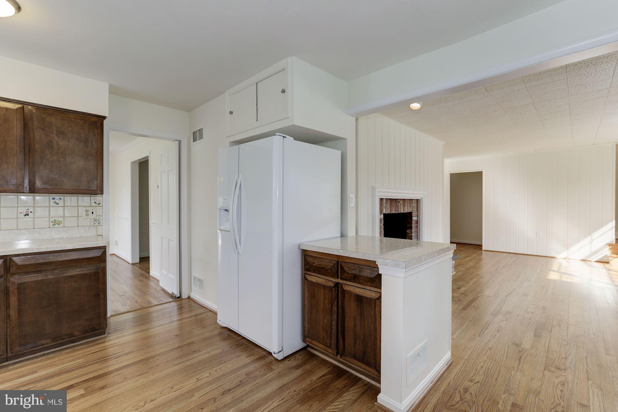 9301 Burning Tree Road Bethesda, MD 20817 - Photo 7 of 30 Kitchen Opening to Family Room