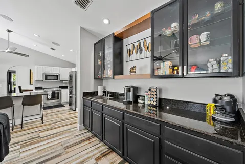 a kitchen with stainless steel appliances lots of counter space and a sink