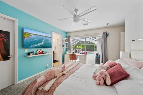 a bedroom with a bed mirror and window