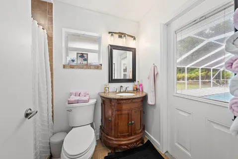 a bathroom with a toilet a sink and a mirror