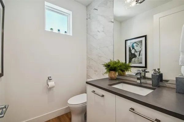 a bathroom with a sink a toilet and mirror