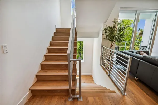 a view of entryway and hall with wooden floor