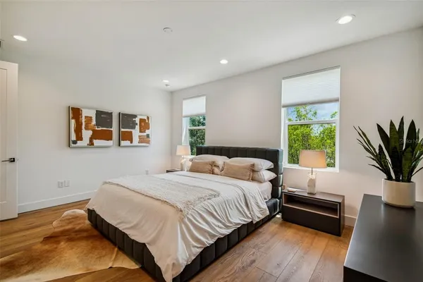 a bedroom with a bed and a potted plant