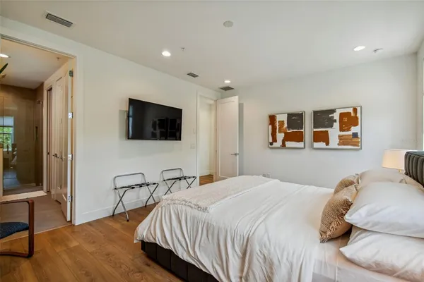 a bedroom with a bed and a flat screen tv