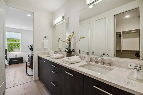 a bathroom with a granite countertop sink double vanity and a mirror