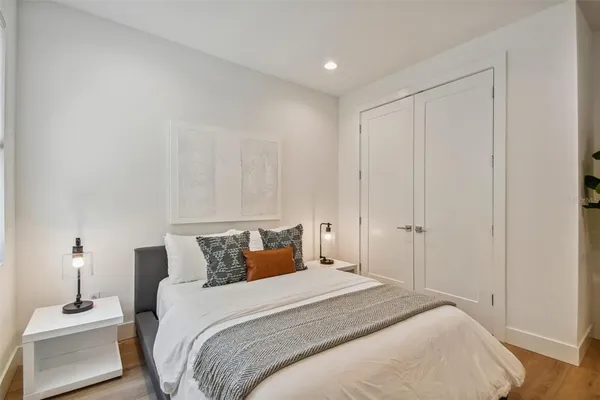 a bedroom with a bed and a lamp