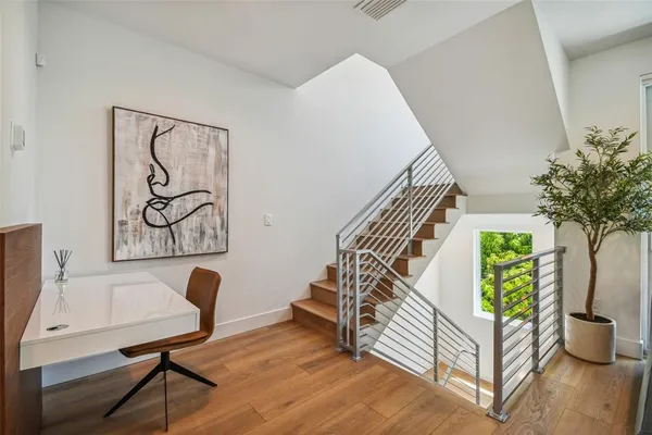 a view of entryway and hall with wooden floor