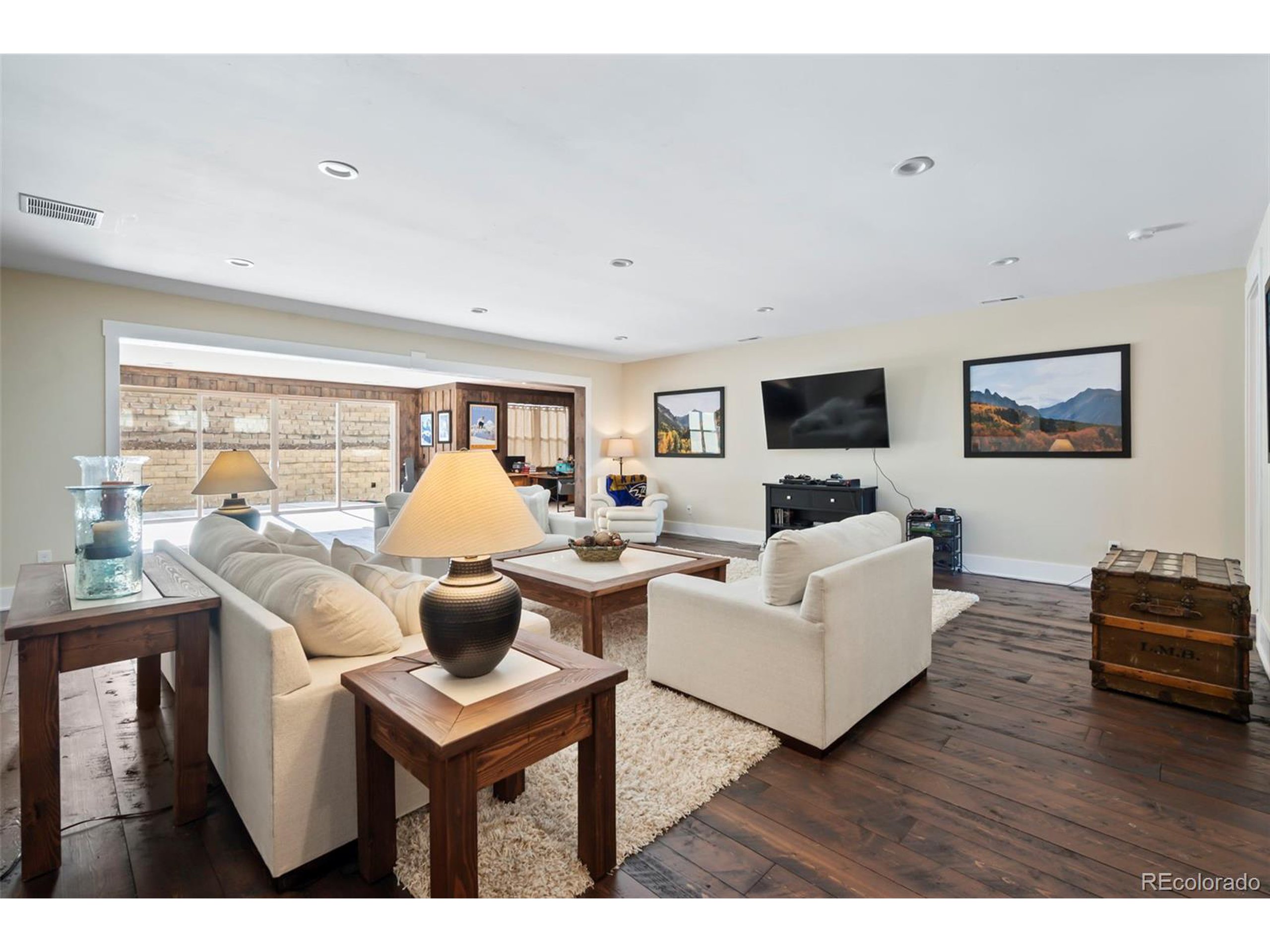 4694 Settlers Ridge Road Colorado Springs, CO 80908 - Photo 20 of 43 a living room with furniture a flat screen tv and a floor to ceiling window