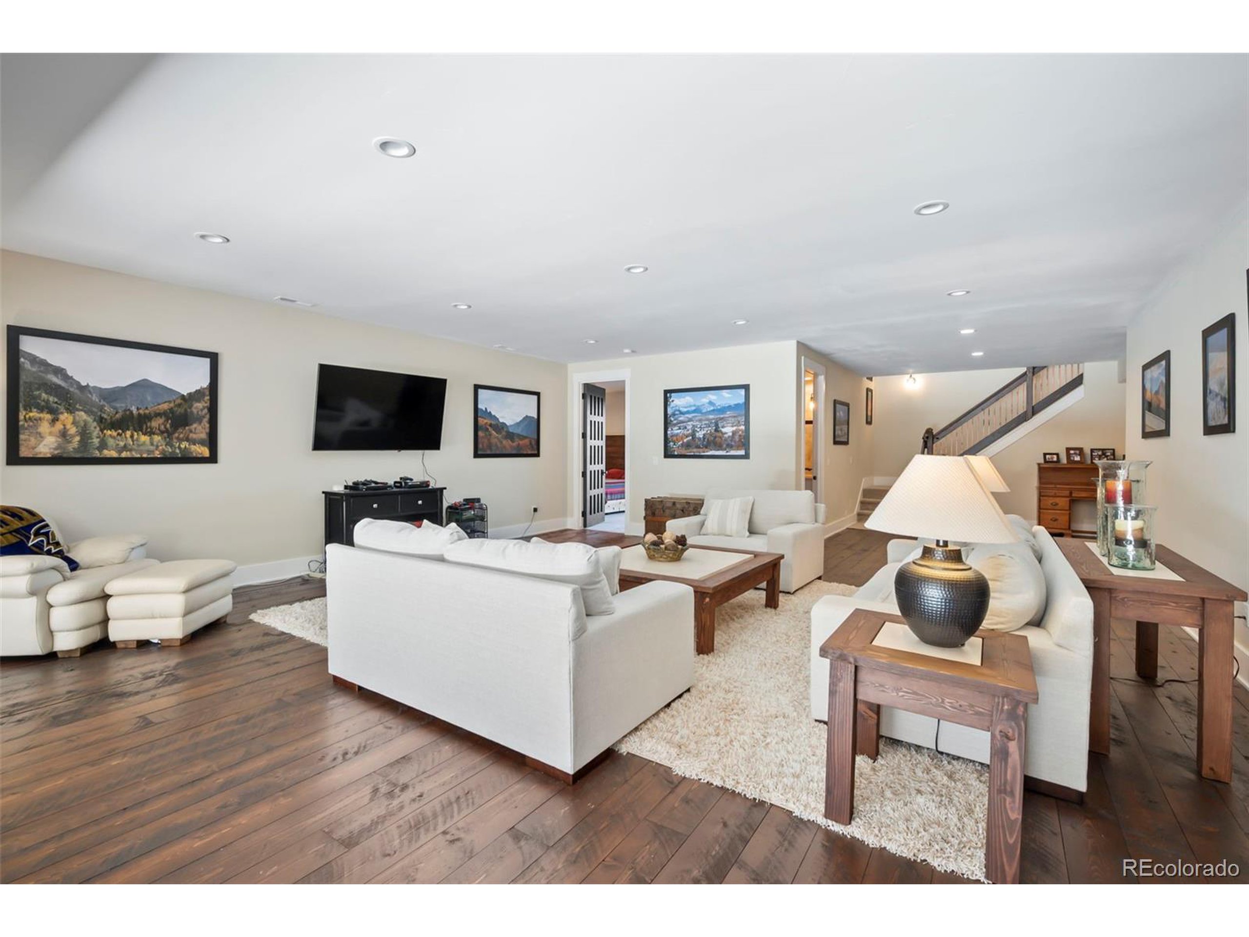 4694 Settlers Ridge Road Colorado Springs, CO 80908 - Photo 21 of 43 a living room with furniture and a flat screen tv