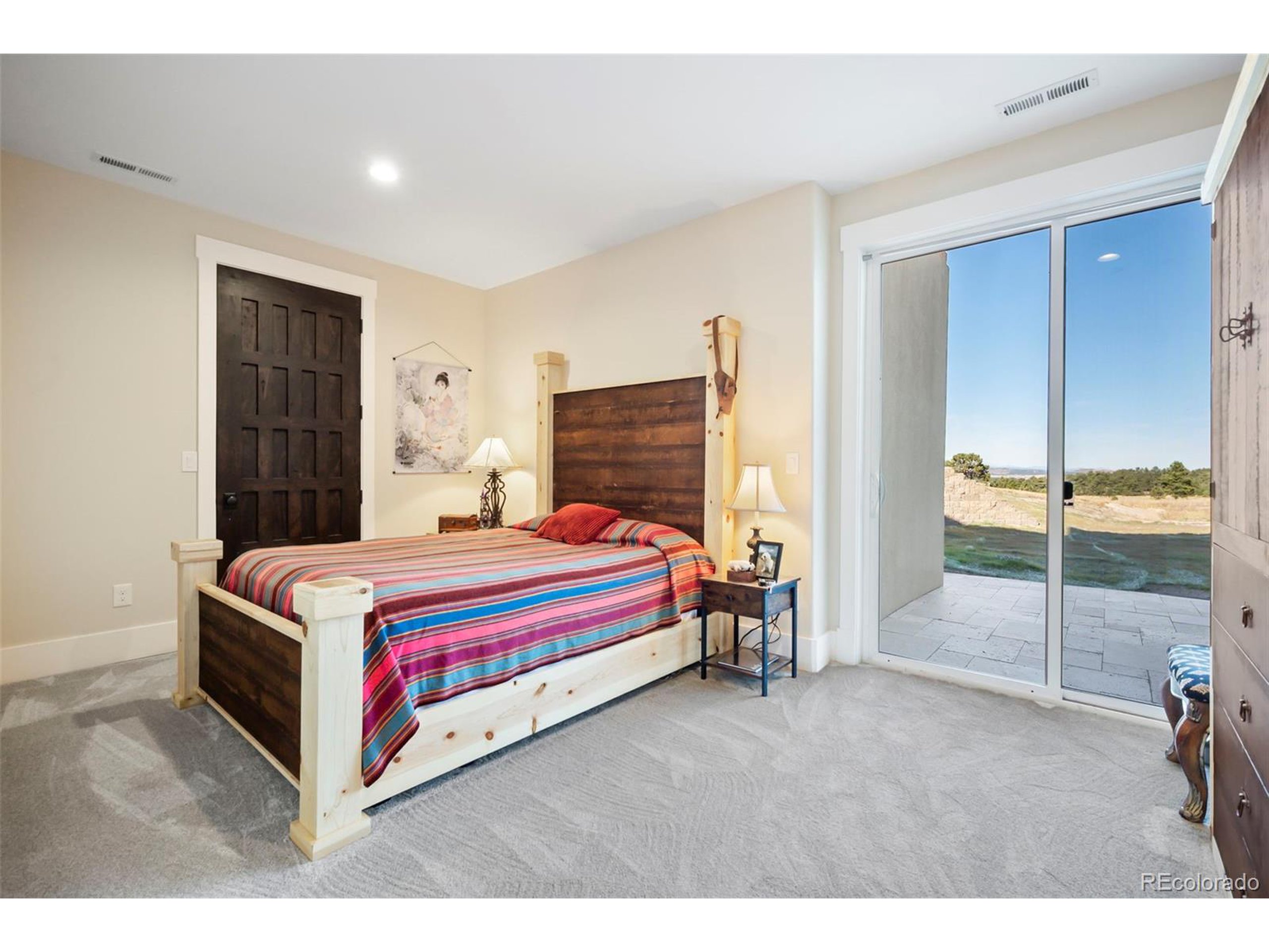 4694 Settlers Ridge Road Colorado Springs, CO 80908 - Photo 27 of 43 a room with a bed and a view of living room