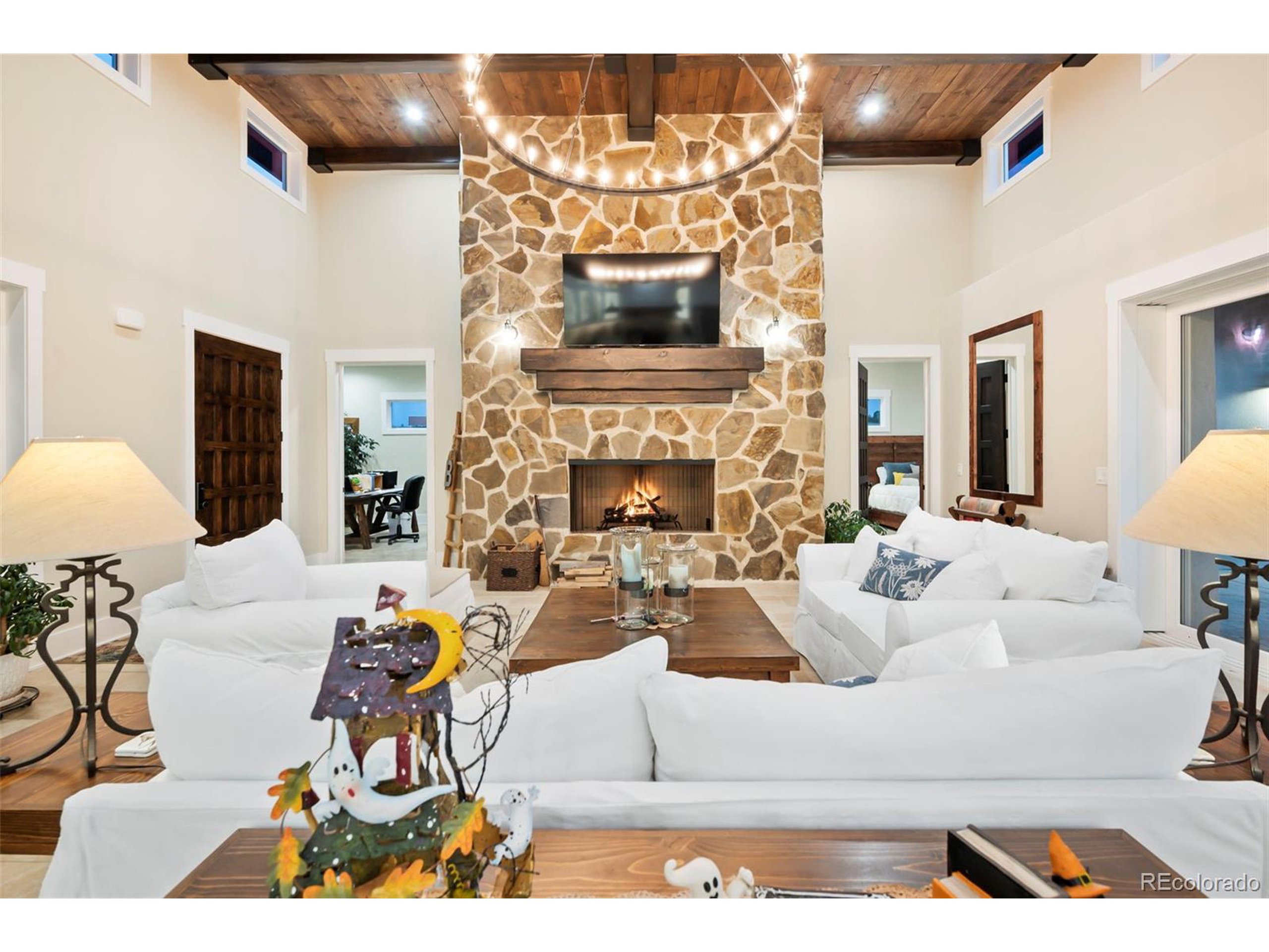 4694 Settlers Ridge Road Colorado Springs, CO 80908 - Photo 32 of 43 a living room with furniture a fireplace and a flat screen tv