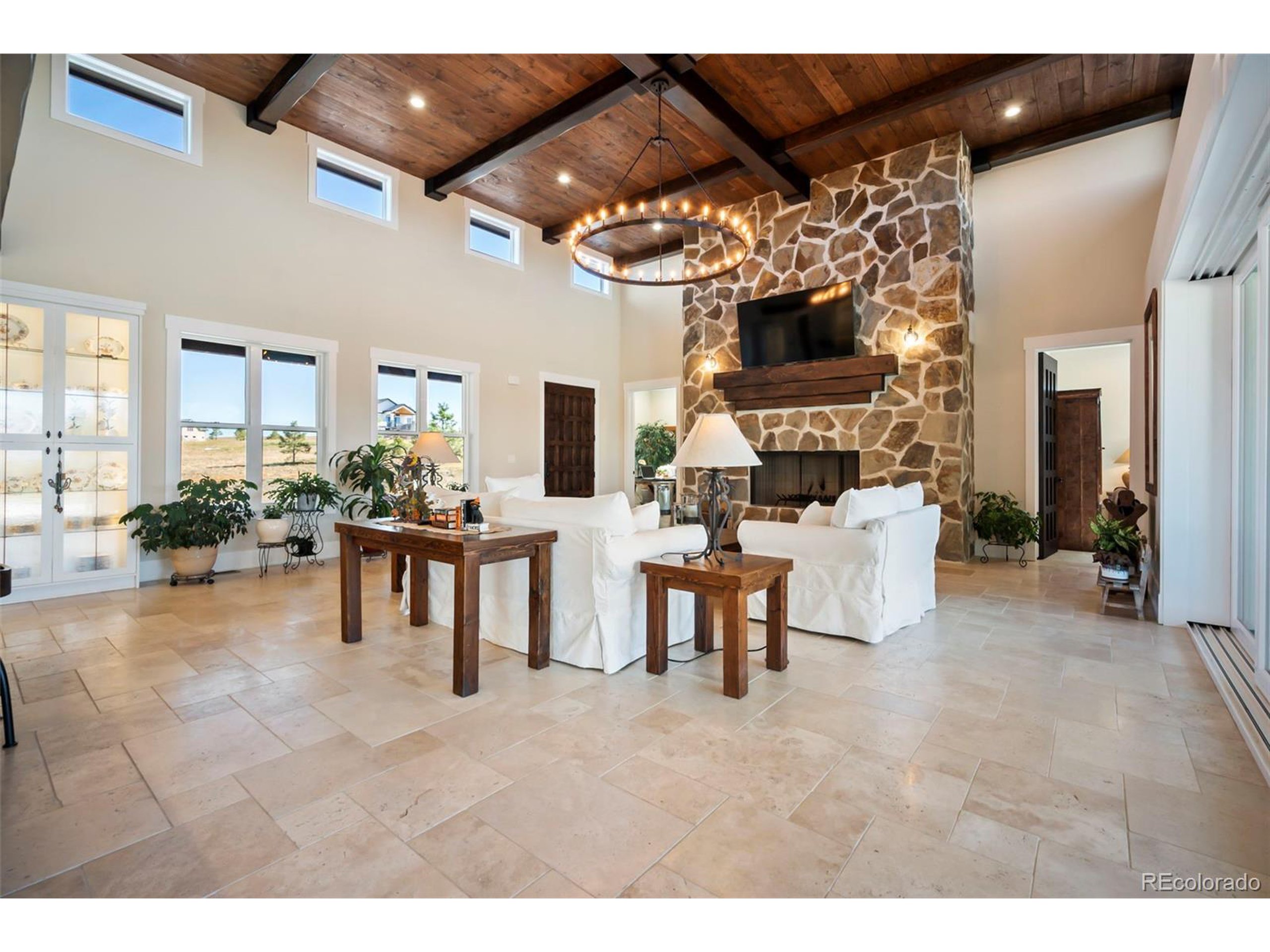 4694 Settlers Ridge Road Colorado Springs, CO 80908 - Photo 4 of 43 a living room with furniture and a flat screen tv