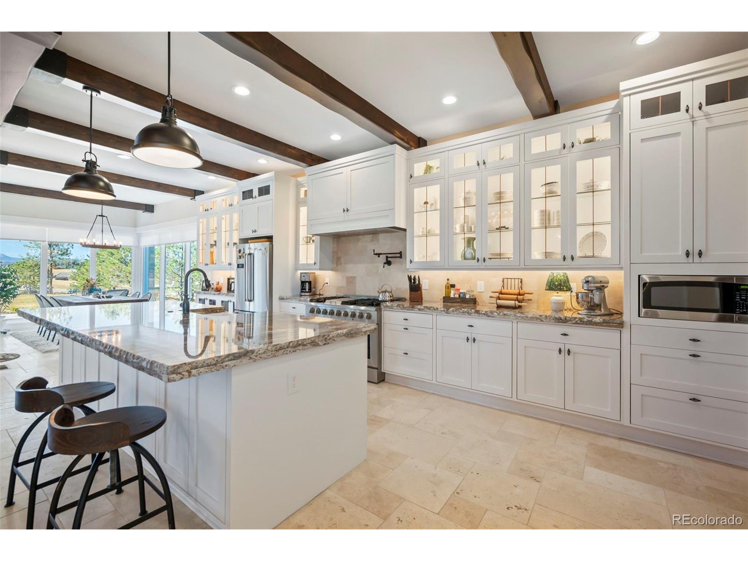 4694 Settlers Ridge Road Colorado Springs, CO 80908 - Photo 7 of 43 a kitchen with counter top space and wooden floor