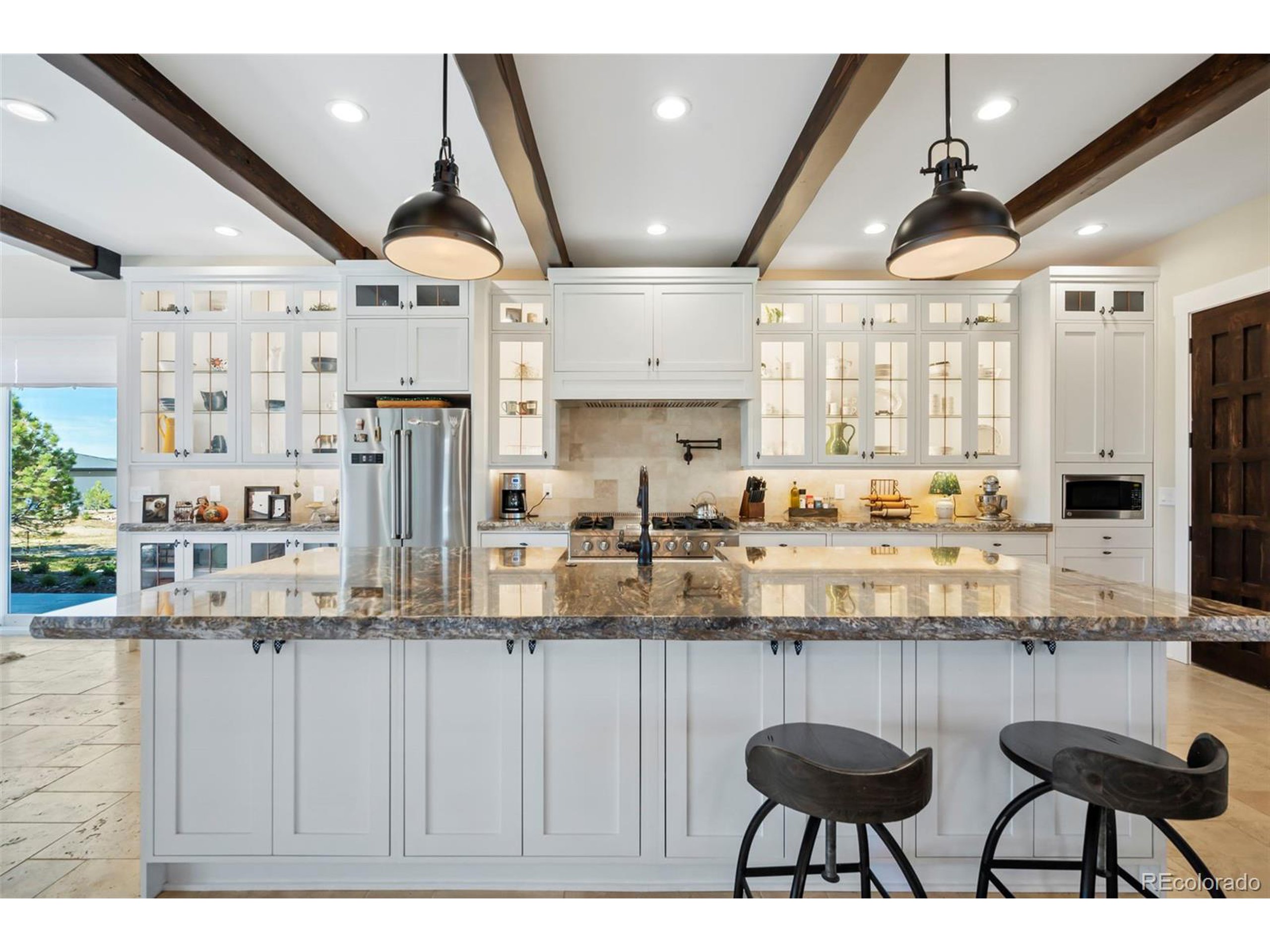 4694 Settlers Ridge Road Colorado Springs, CO 80908 - Photo 8 of 43 a kitchen with lots of counter space and windows