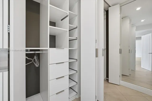 a bathroom with a toilet sink vanity and mirror