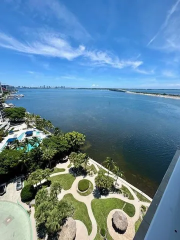 an empty room with windows and view of an empty room