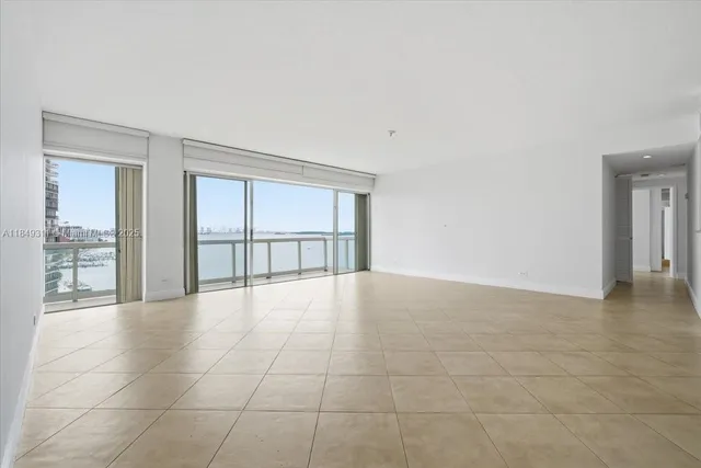 a view of kitchen with granite countertop cabinets and refrigerator