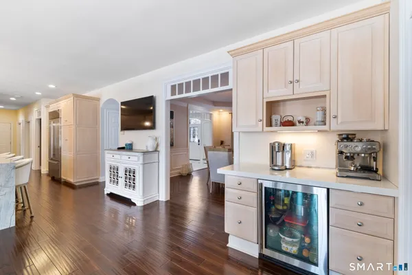 a kitchen with stainless steel appliances a microwave a stove a refrigerator cabinets and wooden floor