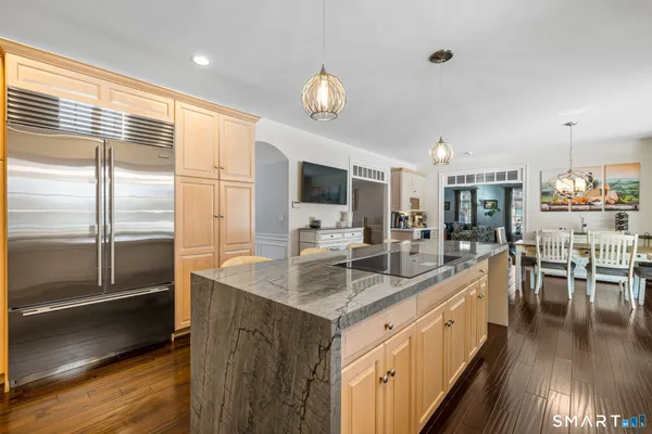 a kitchen with stainless steel appliances granite countertop a sink stove and a refrigerator