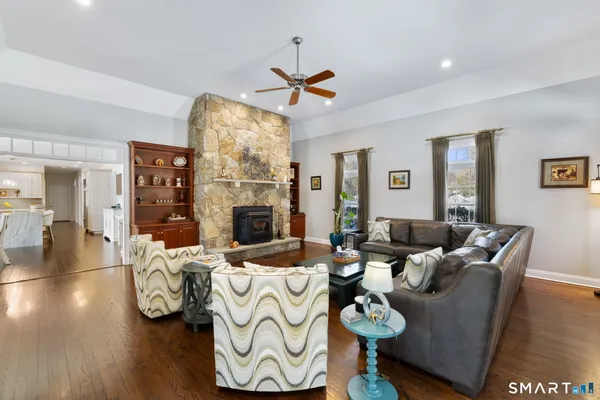 a living room with furniture a fireplace and a chandelier