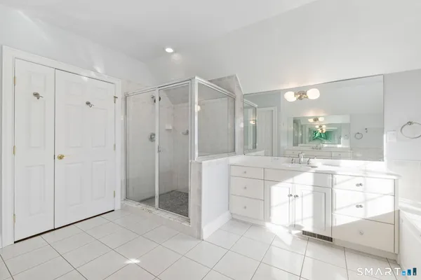 a bathroom with a sink mirror and a bathtub